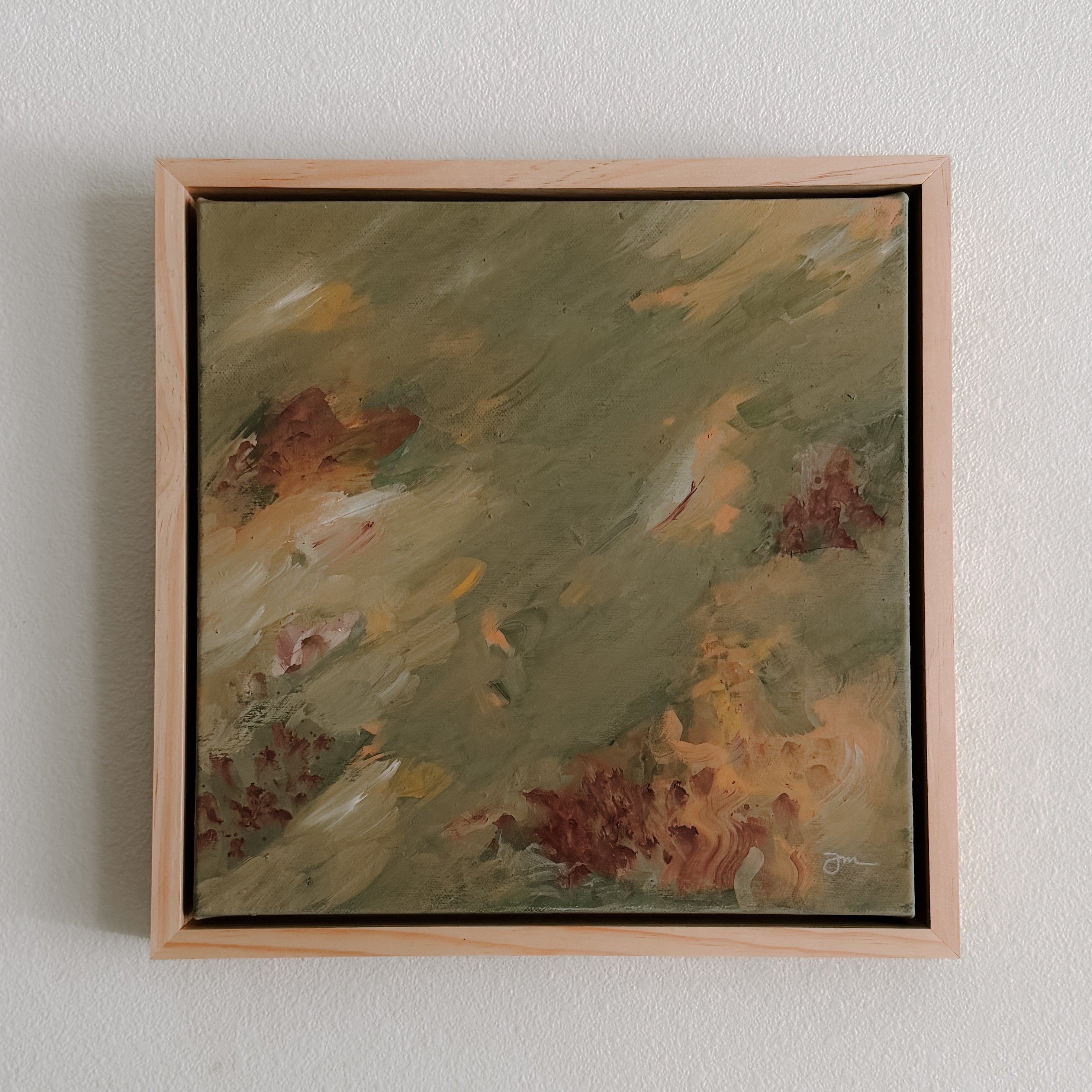 Framed abstract painting on a white wall